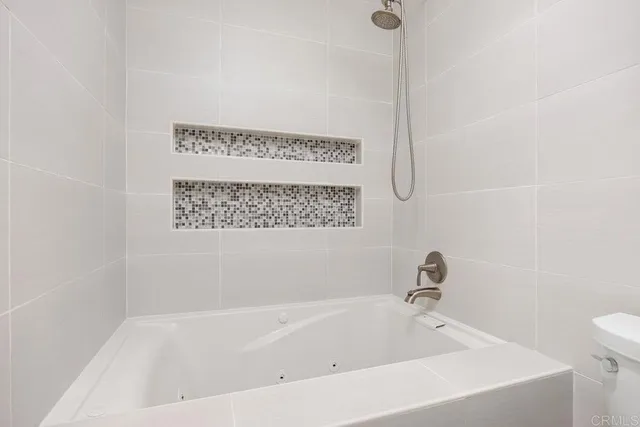 a view of a bedroom with wooden floor and a window