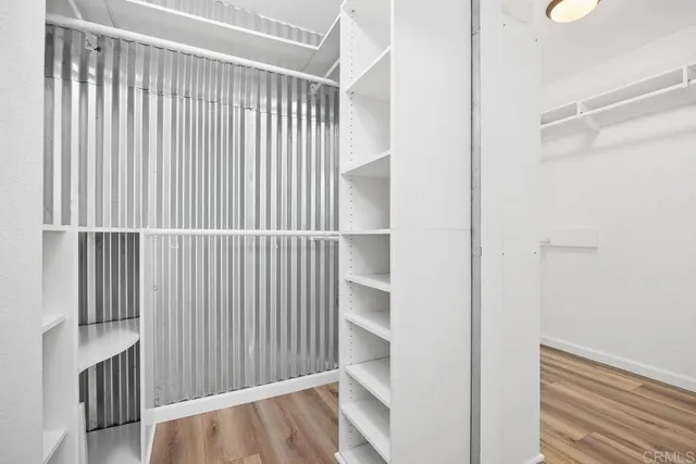 a view of a room with wooden floor and a window