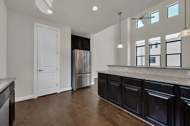 a kitchen with stainless steel appliances granite countertop a refrigerator and a sink