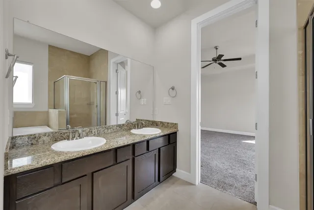 a bathroom with a granite countertop sink a mirror and a