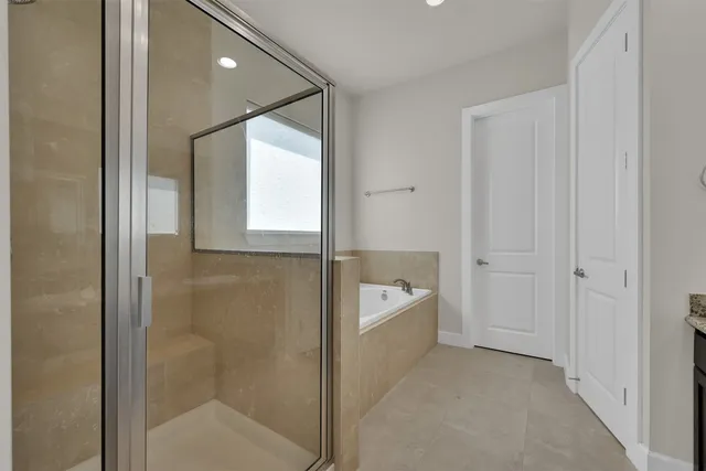 a bathroom with a bathtub shower and toilet