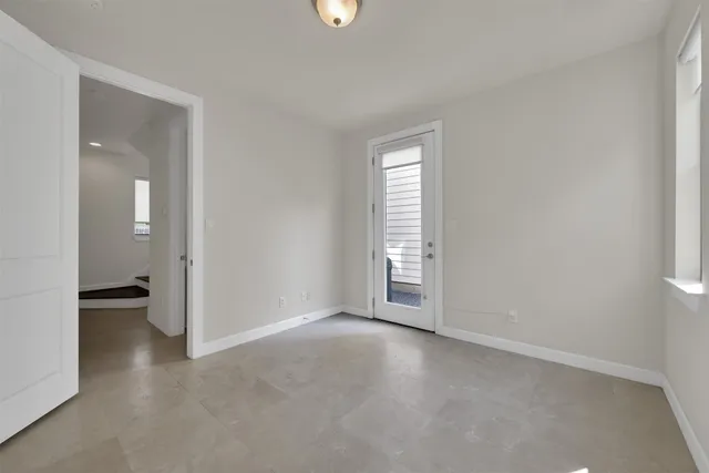 an empty room with windows and closet