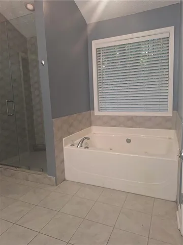 a bathroom with a bathtub and shower