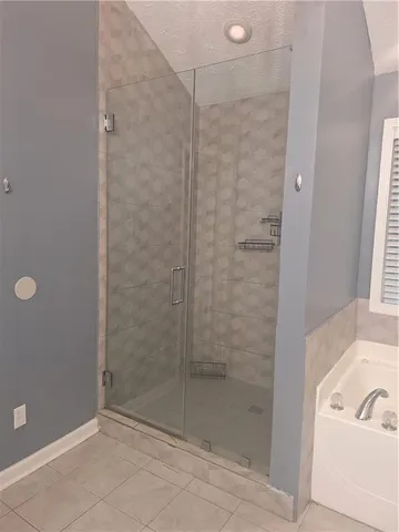 a bathroom with a bathtub and a shower