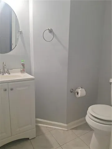 a bathroom with a granite countertop toilet and a sink