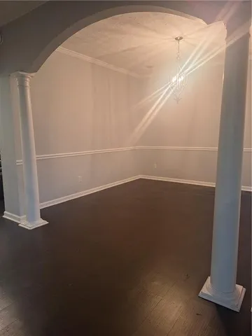 an empty room with a wooden door and a window