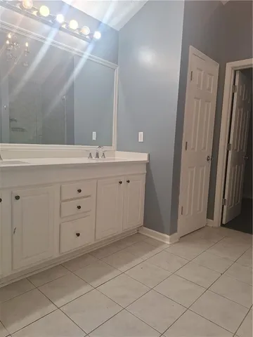 a bathroom with a sink vanity and mirror