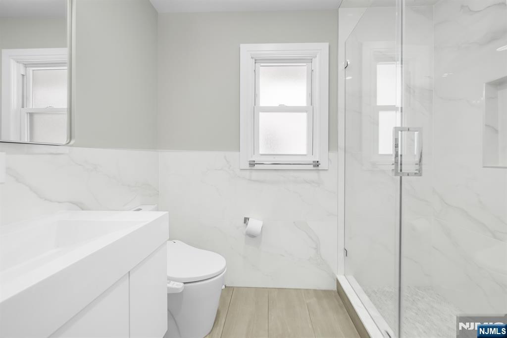 475 Cedar Lane Paramus, NJ 07652 - Photo 11 of 31 a bathroom with a sink a toilet and shower