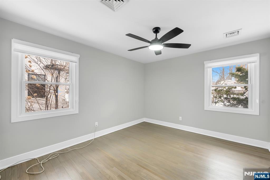 475 Cedar Lane Paramus, NJ 07652 - Photo 13 of 31 a view of an empty room with a window and a ceiling fan