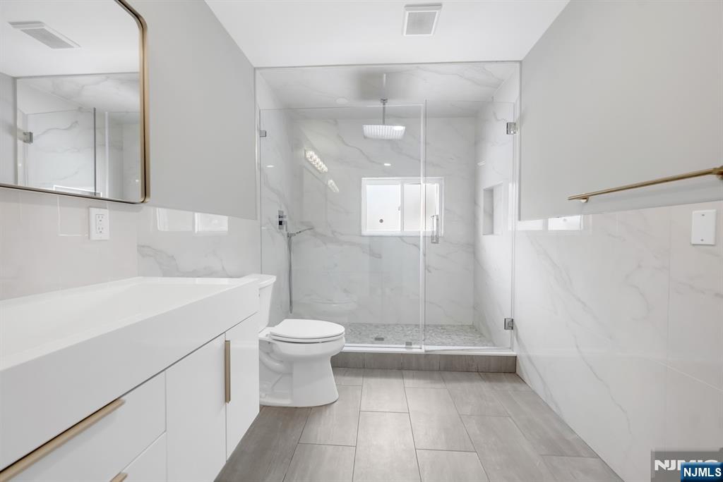 475 Cedar Lane Paramus, NJ 07652 - Photo 18 of 31 a bathroom with a sink a toilet and shower