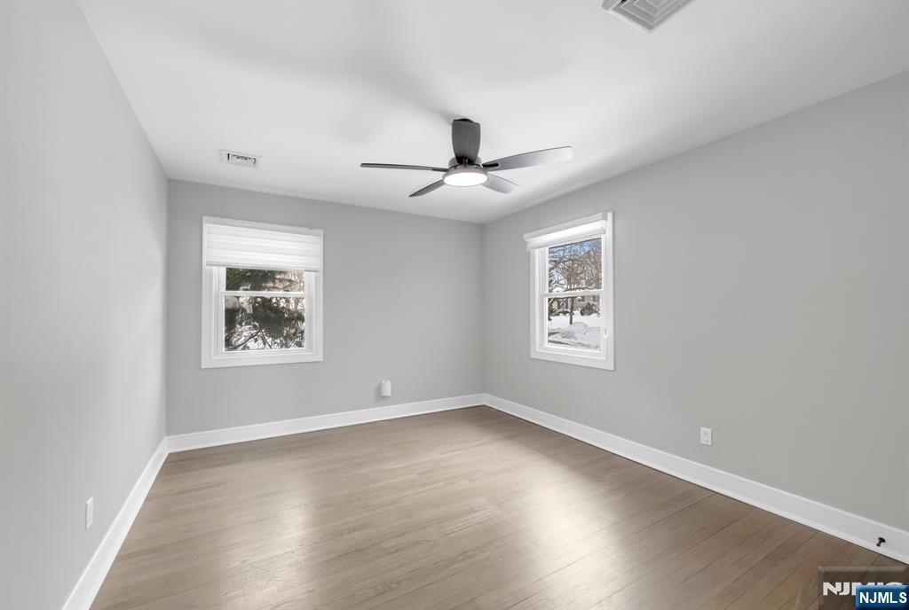 475 Cedar Lane Paramus, NJ 07652 - Photo 19 of 31 a view of a big room with wooden floor and windows