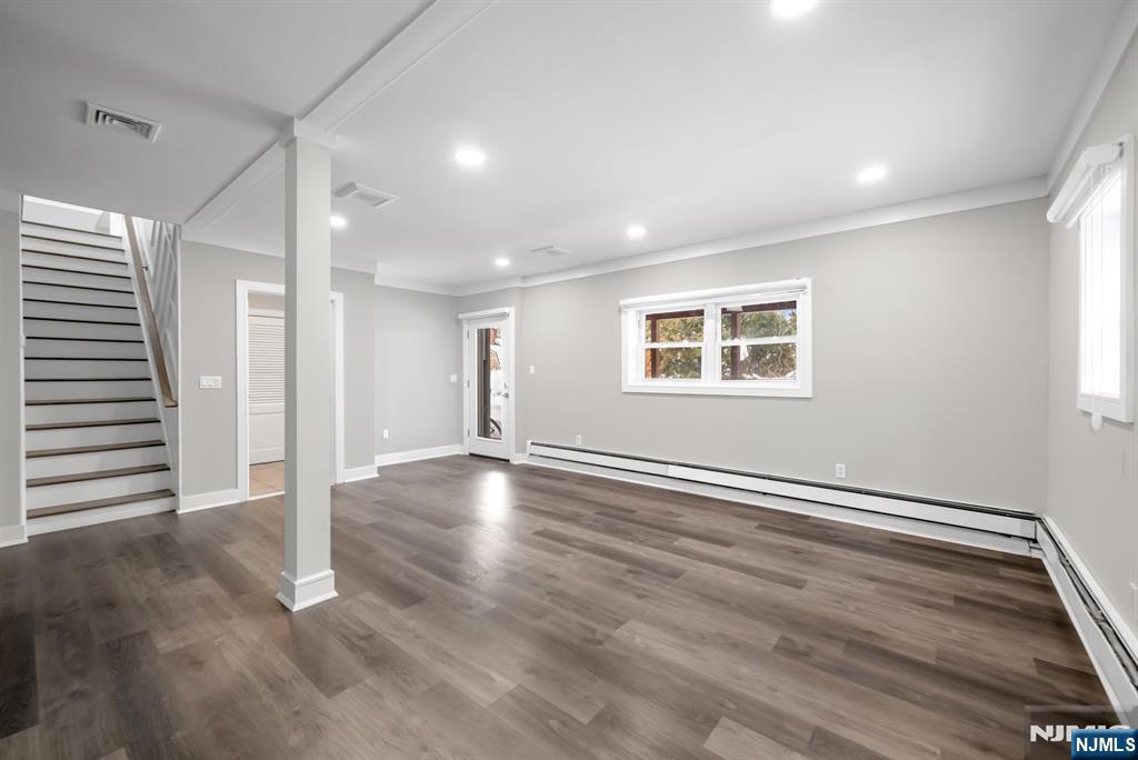 475 Cedar Lane Paramus, NJ 07652 - Photo 21 of 31 an empty room with wooden floor and windows