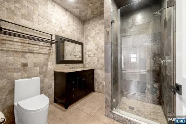 a bathroom with a toilet a sink and glass door