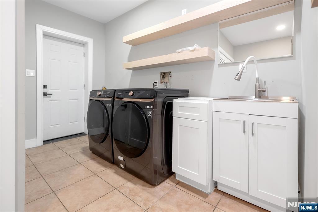 475 Cedar Lane Paramus, NJ 07652 - Photo 23 of 31 a utility room with cabinets washer and dryer
