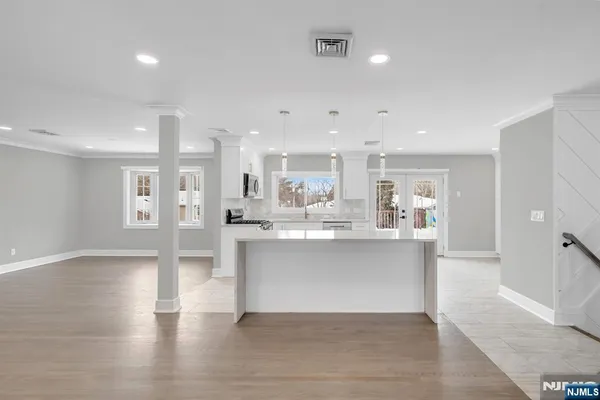 a view of kitchen with stainless steel appliances refrigerator sink and cabinets