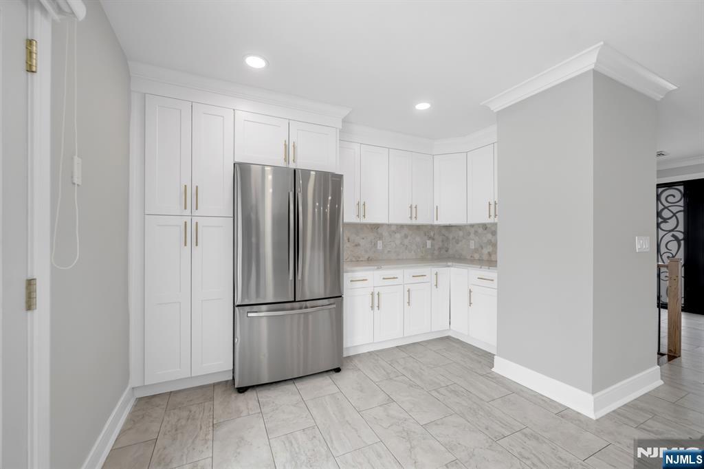 475 Cedar Lane Paramus, NJ 07652 - Photo 7 of 31 a kitchen with granite countertop a refrigerator and a stove top oven