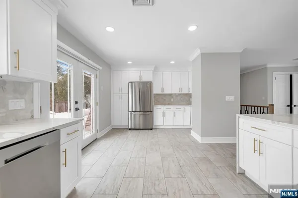 a kitchen with white cabinets and white appliances