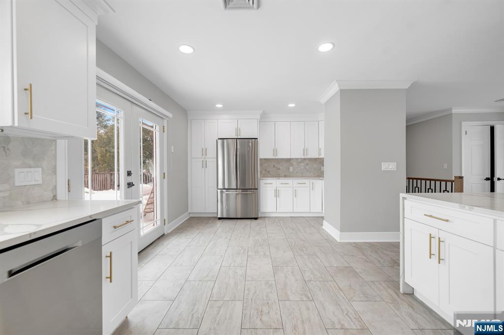 475 Cedar Lane Paramus, NJ 07652 - Photo 8 of 31 a kitchen with white cabinets and white appliances