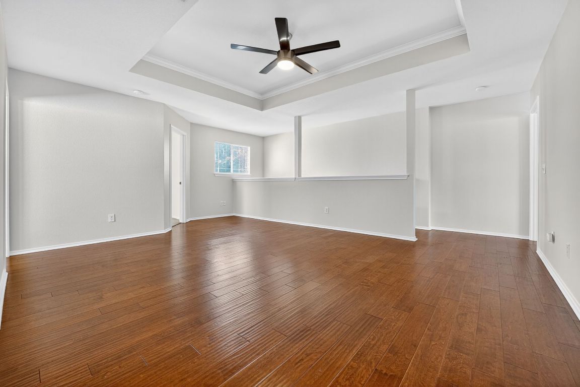 1520 Anise Drive Austin, TX 78741 - Photo 11 of 30 a view of empty room with wooden floor and ceiling fan