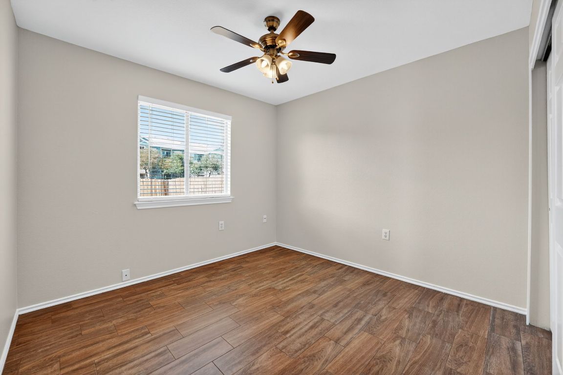 1520 Anise Drive Austin, TX 78741 - Photo 16 of 30 an empty room with wooden floor and windows