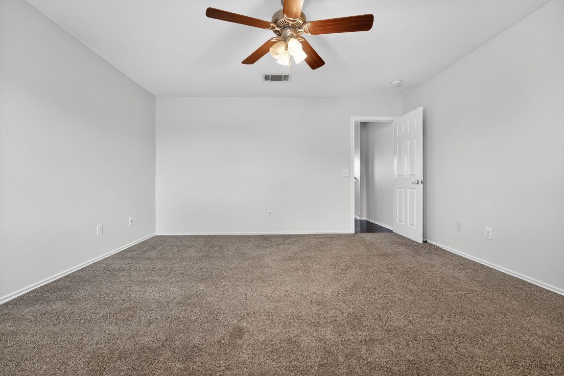 1520 Anise Drive Austin, TX 78741 - Photo 17 of 30 an empty room with chandelier fan
