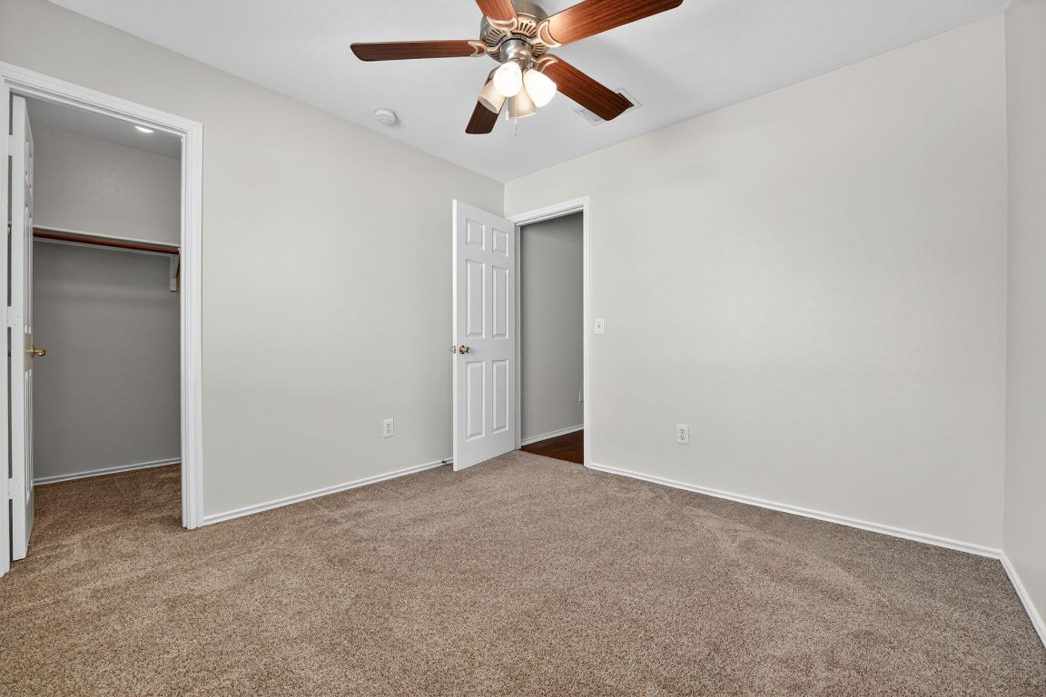 1520 Anise Drive Austin, TX 78741 - Photo 19 of 30 an empty room with closet and a chandelier fan