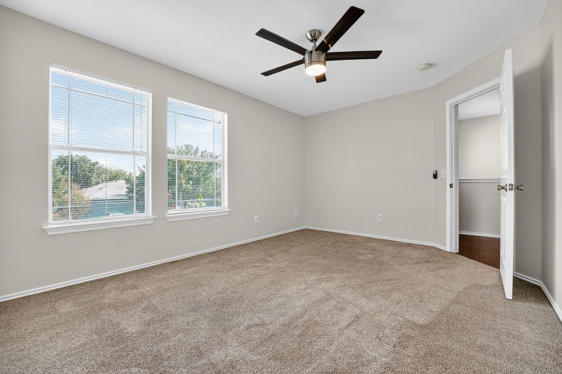 1520 Anise Drive Austin, TX 78741 - Photo 20 of 30 an empty room with a window and a fan
