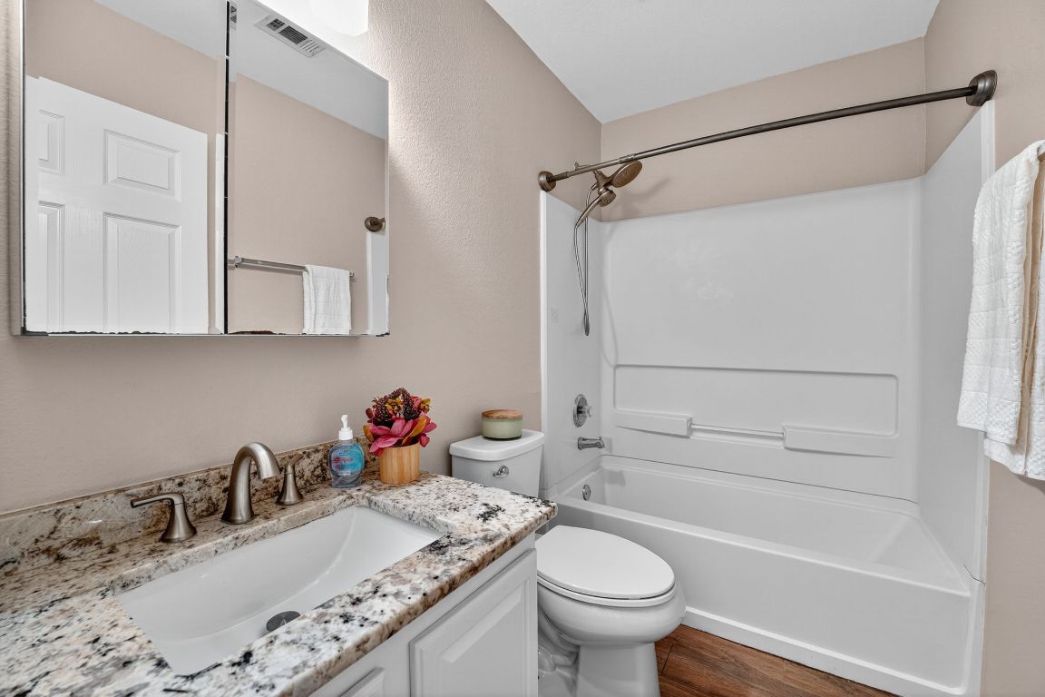 1520 Anise Drive Austin, TX 78741 - Photo 23 of 30 a bathroom with a sink vanity mirror and toilet