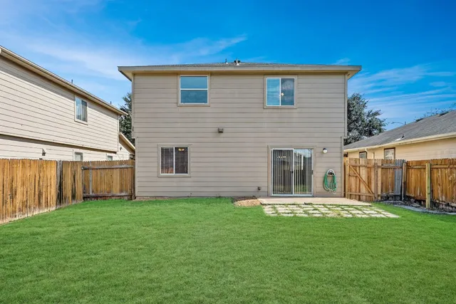 a front view of a house with yard and green space