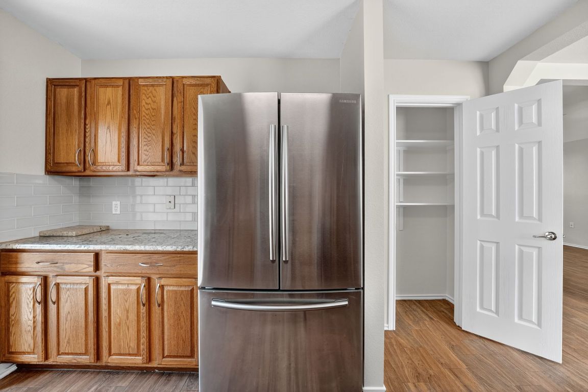 1520 Anise Drive Austin, TX 78741 - Photo 5 of 30 a view of a kitchen with wooden floor and a cabinet