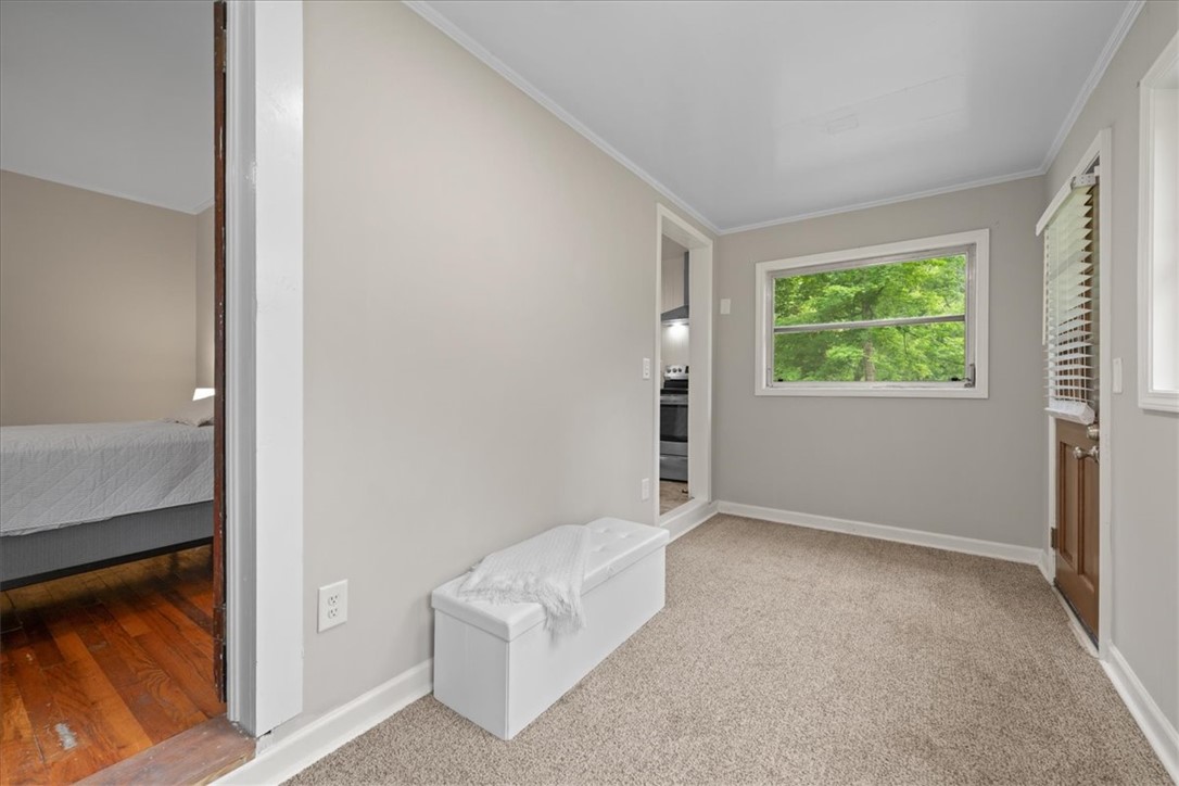 174 Holliday Road Six Mile, SC 29682 - Photo 22 of 49 A well-lit, cozy space offering a clear view of the surrounding trees and connecting rooms