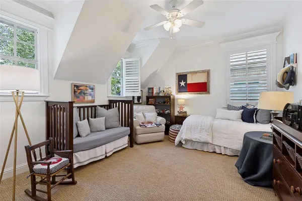 a living room with furniture a bed and a lamp