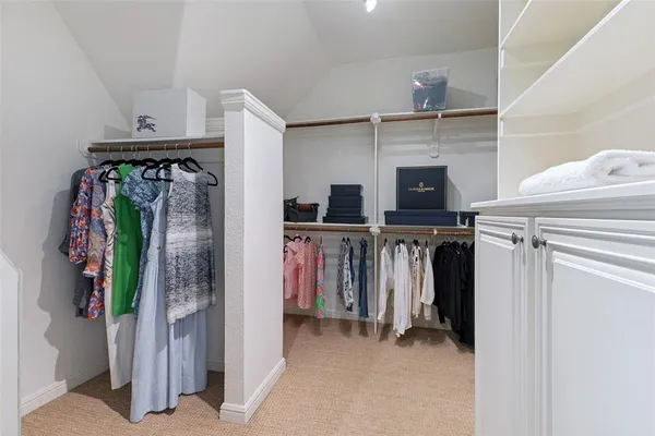 a bedroom with furniture and a flat screen tv