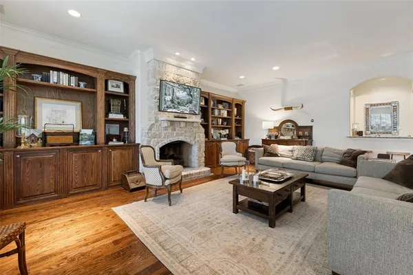 a living room with furniture wooden floor and a large window
