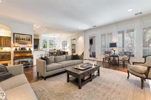 a living room with furniture or kitchen view and a wooden floor