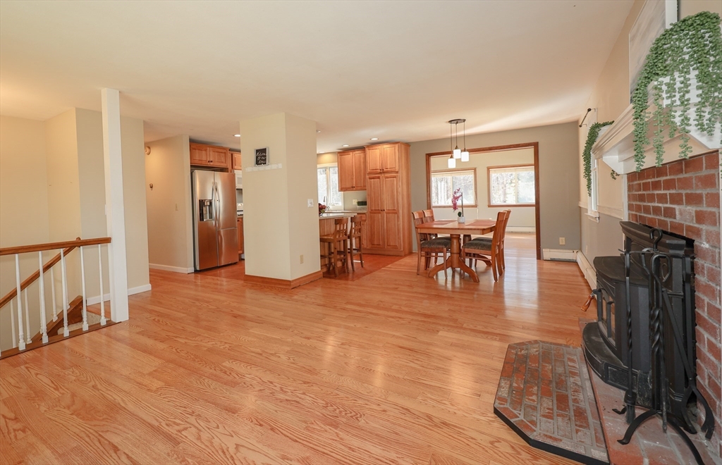 216 North River Road Lee, NH 03861 - Photo 12 of 41 a living room with furniture a fireplace and wooden floor