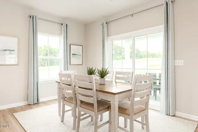 a large kitchen with kitchen island a dining table and chairs