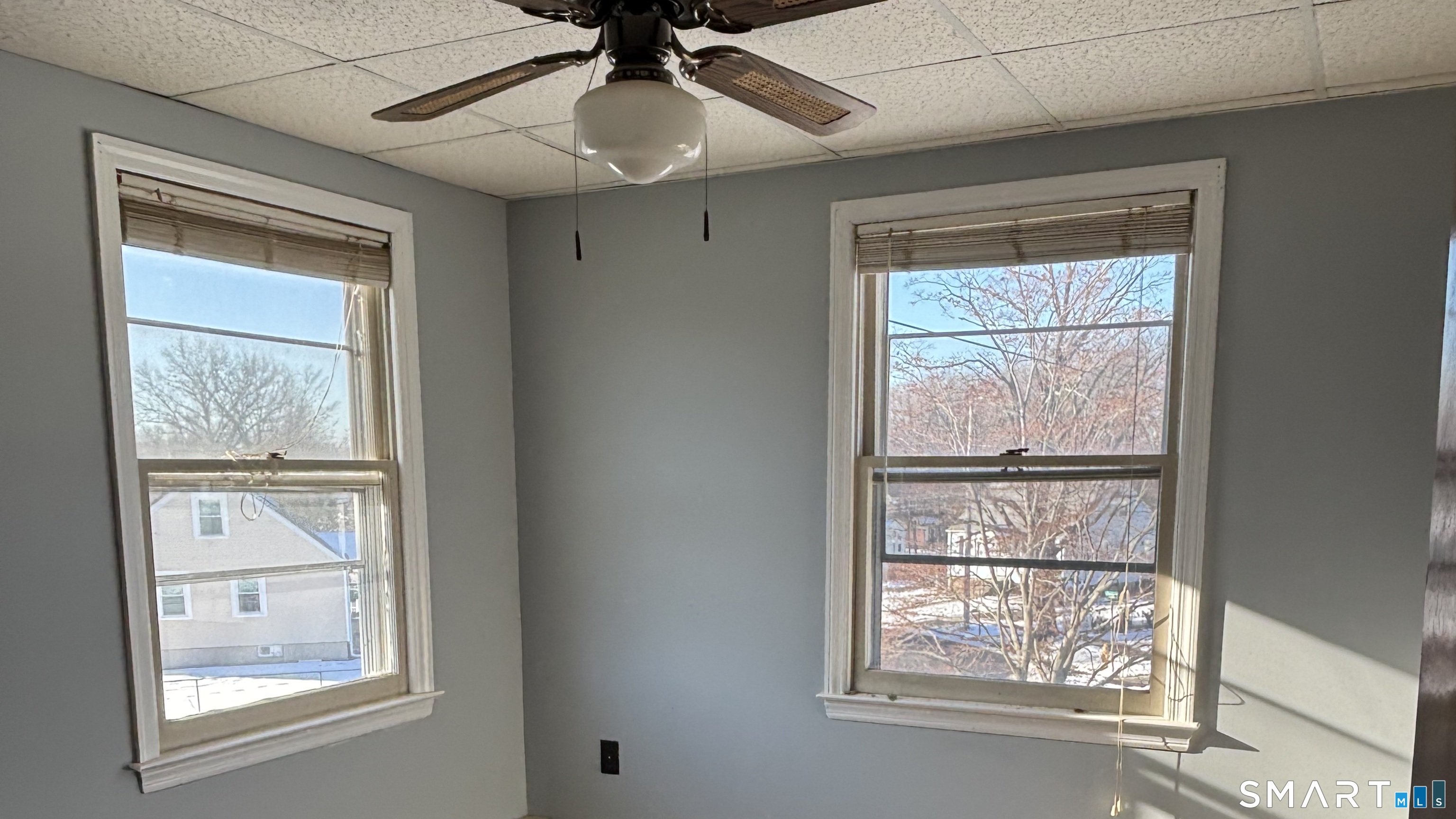 460 Stonybrook Road Stratford, CT 06614 - Photo 12 of 19 an empty room with windows and chandelier fan