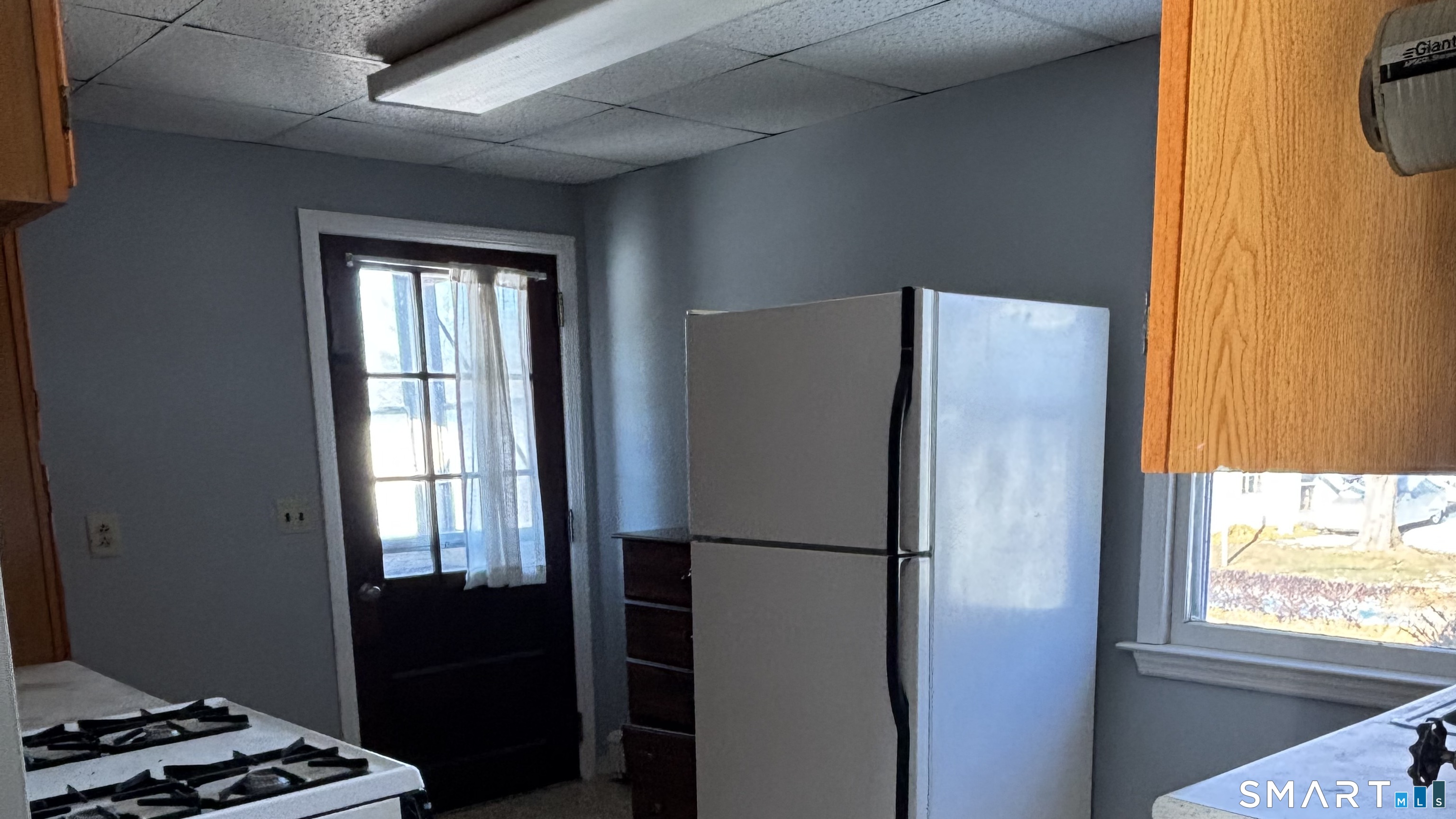 460 Stonybrook Road Stratford, CT 06614 - Photo 16 of 19 a kitchen with a refrigerator and a window