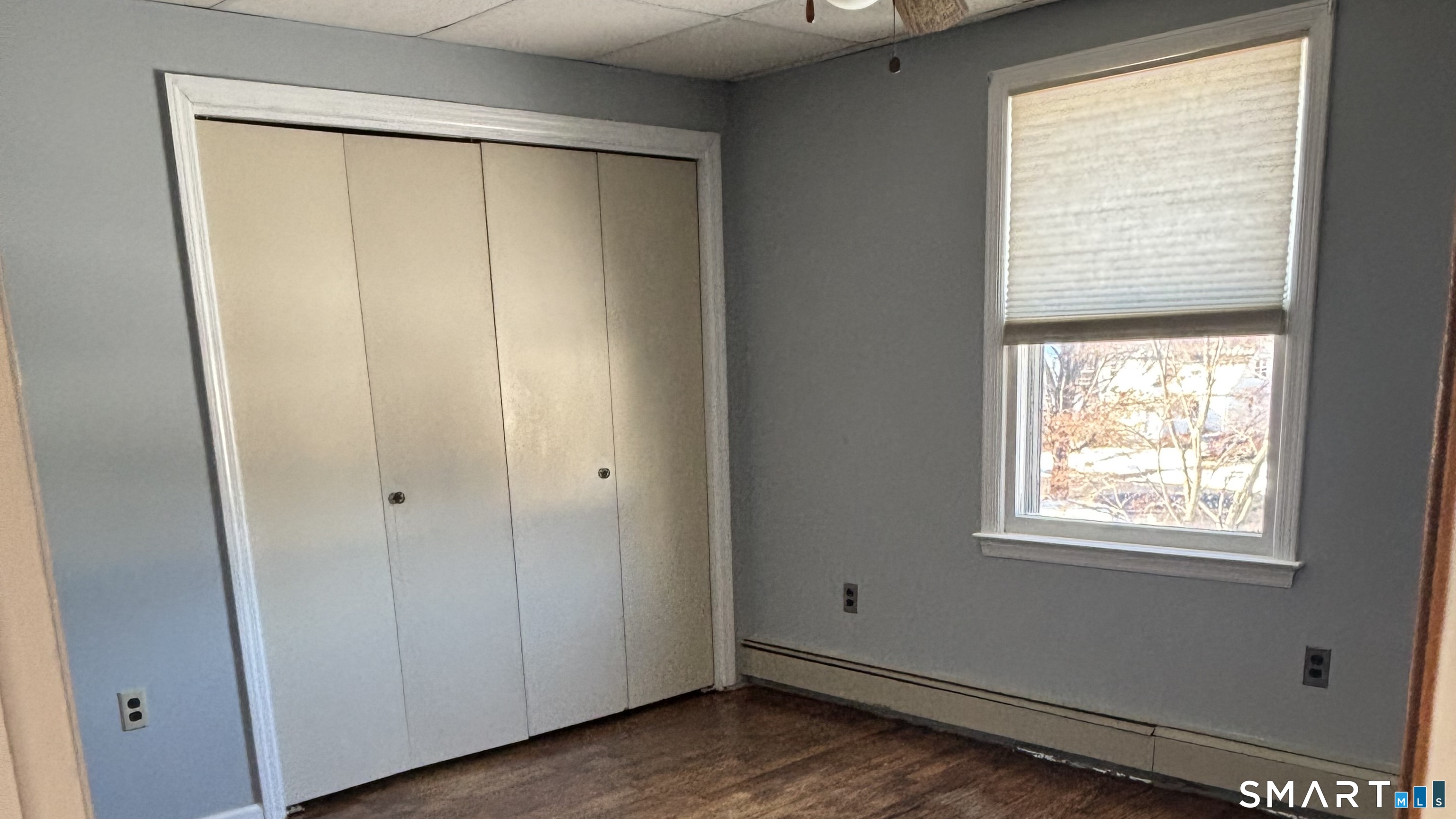 460 Stonybrook Road Stratford, CT 06614 - Photo 17 of 19 a view of an empty room with wooden floor and a window
