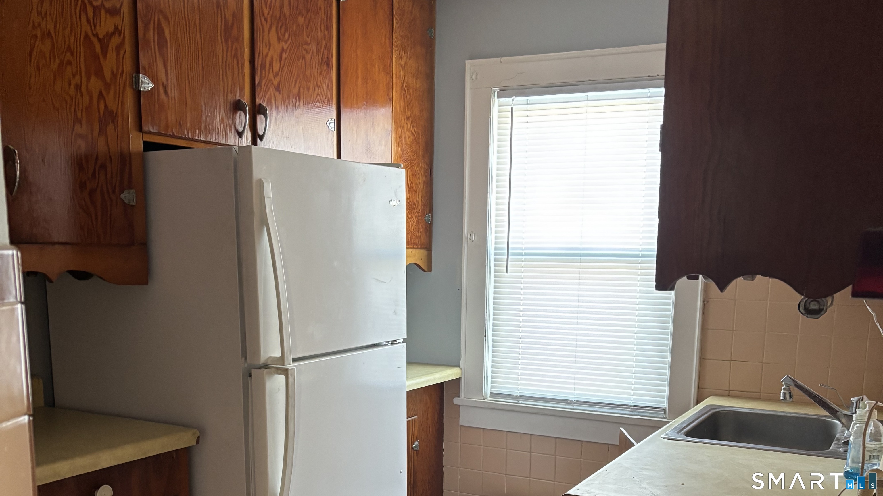 460 Stonybrook Road Stratford, CT 06614 - Photo 8 of 19 a white refrigerator freezer and a window