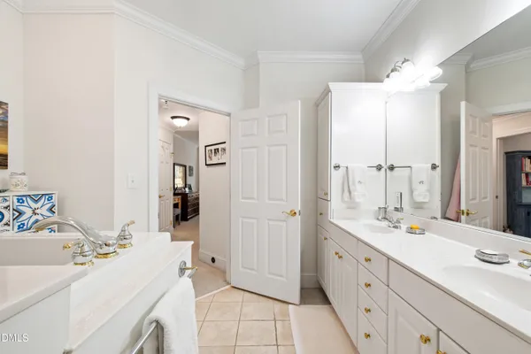 a bathroom with double vanity sink a vanity and a mirror