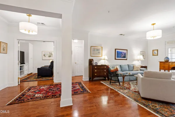 a living room with furniture and a book shelf