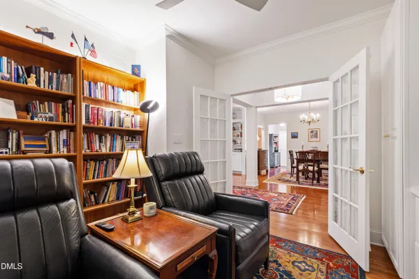 a living room with furniture a fireplace and a large mirror