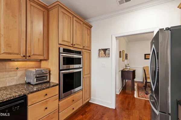 a living room with furniture and a dining table with wooden floor