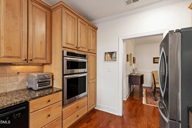 a living room with furniture and a dining table with wooden floor