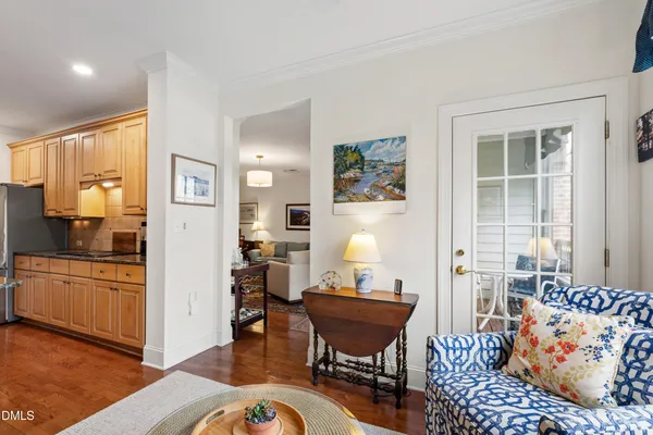 a balcony with couple of chairs and a table