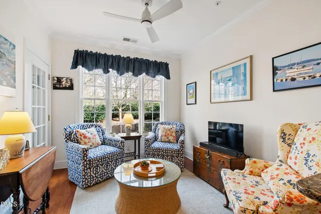 a living room with furniture fireplace and a large window