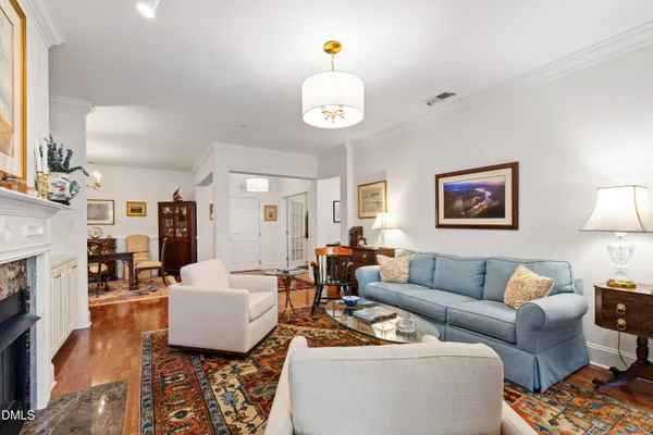 a living room with furniture a fireplace and a table