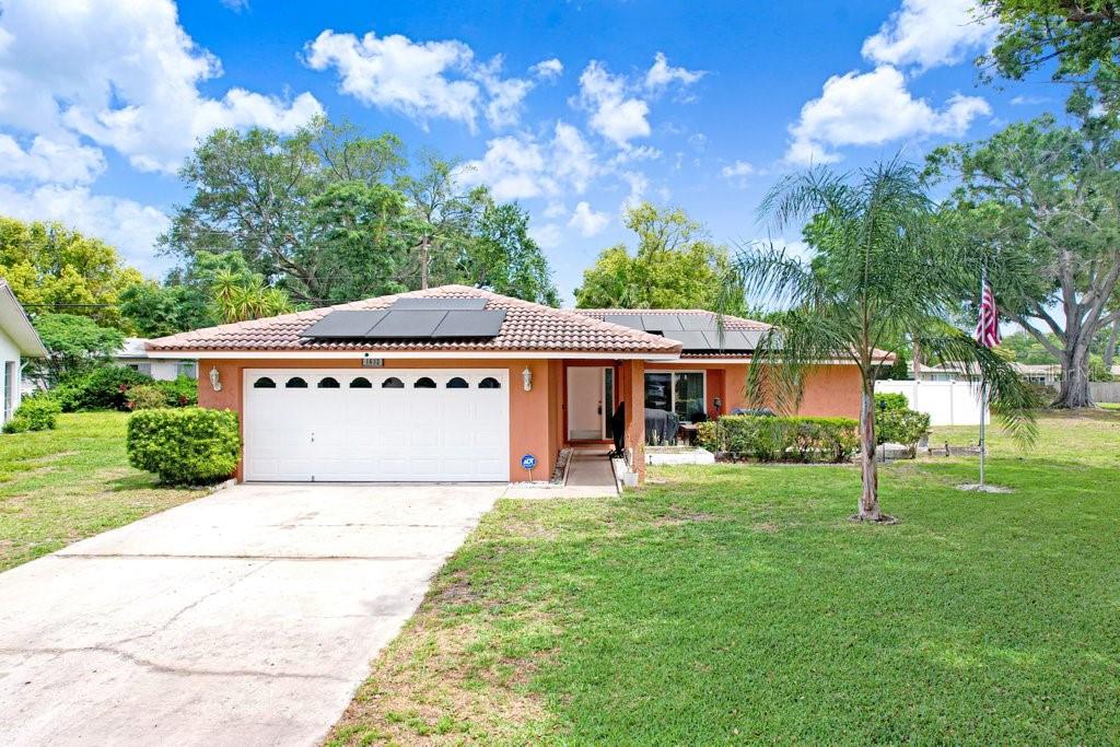 1632 Heather Place Palm Harbor, FL 34684 - Photo 1 of 53 a front view of a house with garden